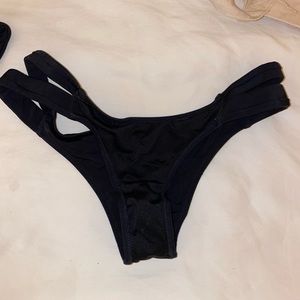 Black bathing suit bottoms with side cut out detail